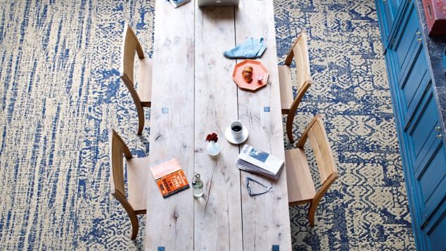 Interface PM37 and PM01 plank carpet tile with PM38 carpet tile in overhead view of seating area with wooden table and chairs