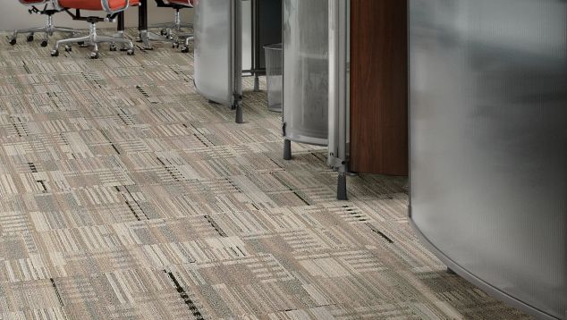 Interface Remade carpet tile in open hallway with seating area in background