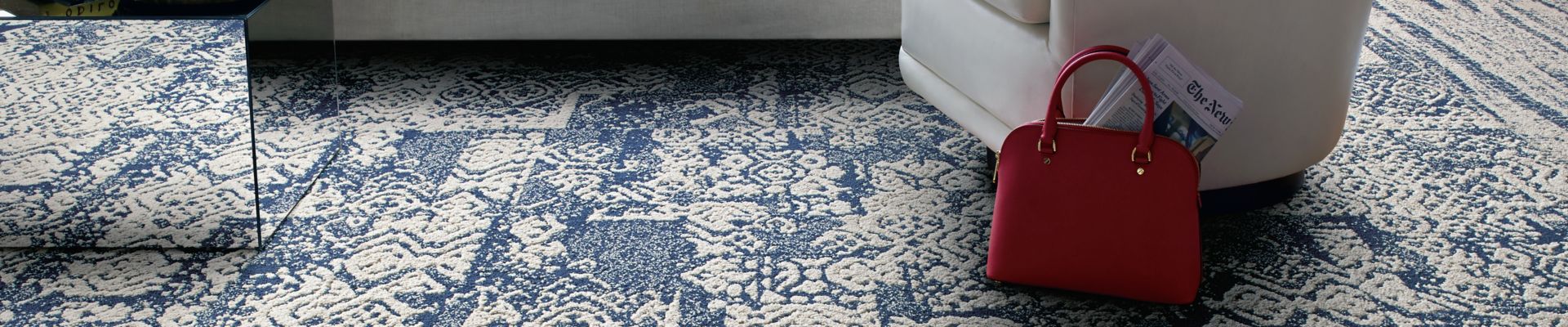 Interface PM01, PM39, and PM49 plank carpet tile in naturally lighted living room area with white furniture and red throw pillows