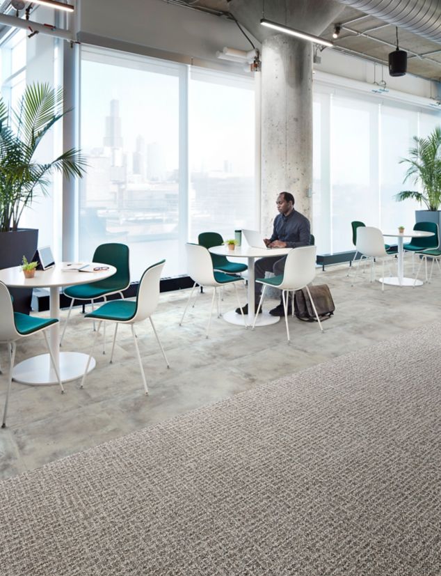 Interface Open Air 415 carpet tile with Textured Stones LVT in casual seating area