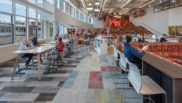 Interface The Standard and Ice Breaker carpet tile with Textured Woodgrains LVT in middle school shared space cafeteria and library