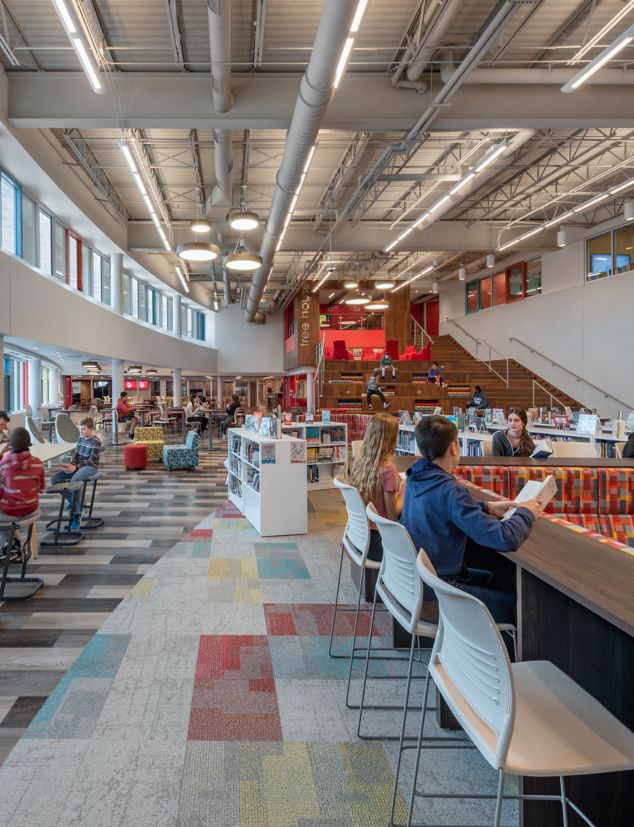 Interface The Standard and Ice Breaker carpet tile with Textured Woodgrains LVT in middle school shared space cafeteria and library