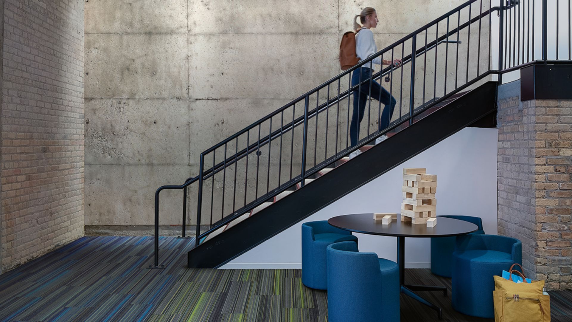 Interface Translucent and Aglow plank carpet tile in open area with man climbing stairs
