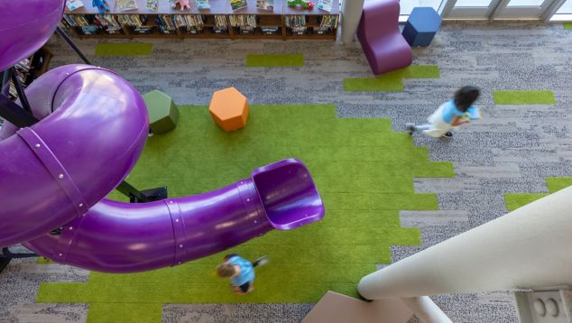 Interface, HN830, HN840 and HN850 plank carpet tile in K-12 library with coiled purple slide