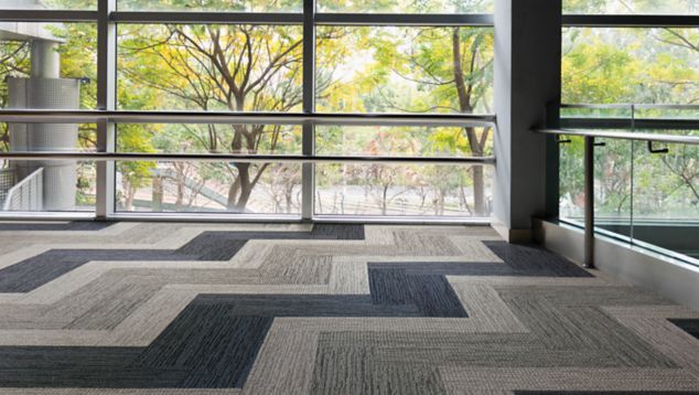 Interface Afternoon Light and Winter Sun carpet tile in open area with glass walls