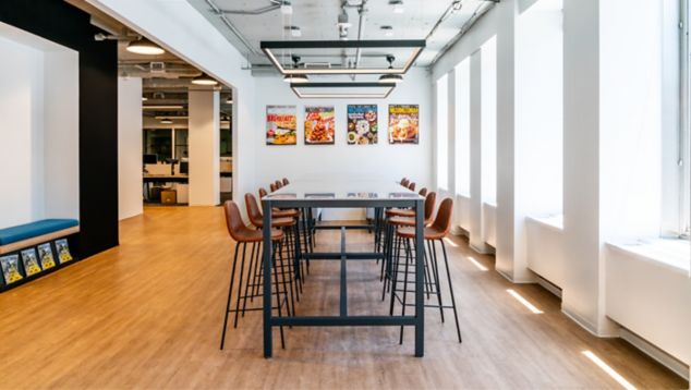 Interface Steady Stride LVT in meeting area with large windows and artwork on wall