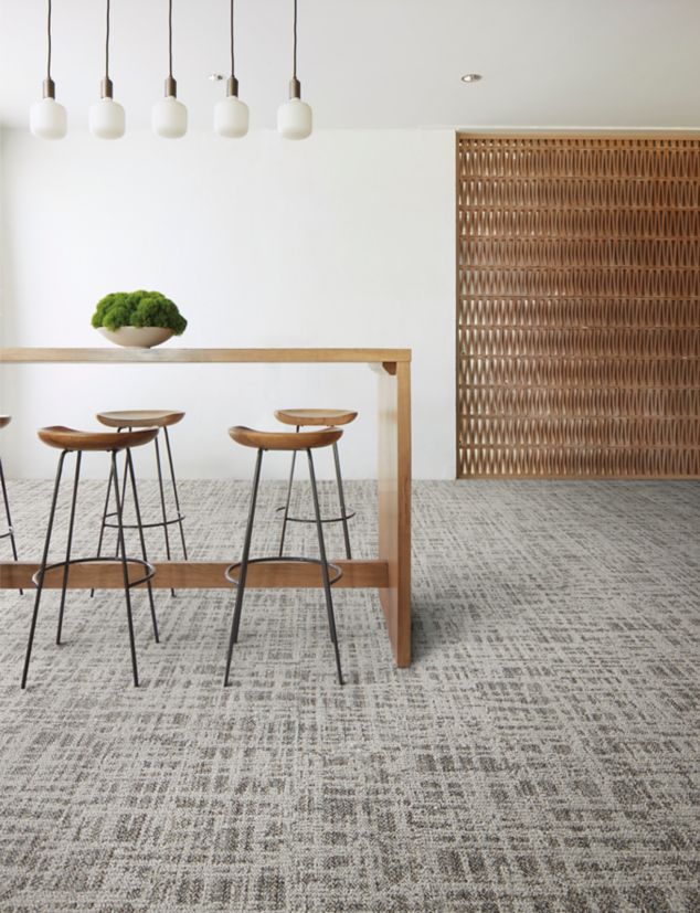 Interface Deckled plank carpet tile in common area with bar and stools