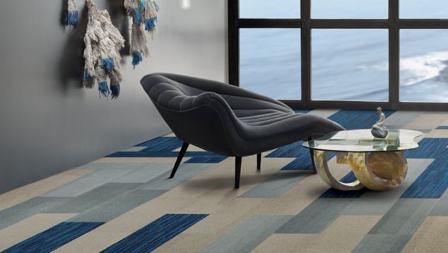 Interface B701 and B703 plank carpet tile in seating area with multi-paned window and net lamp
