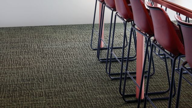 Interface Brownstone plank carpet tile in break area with long table and flowers