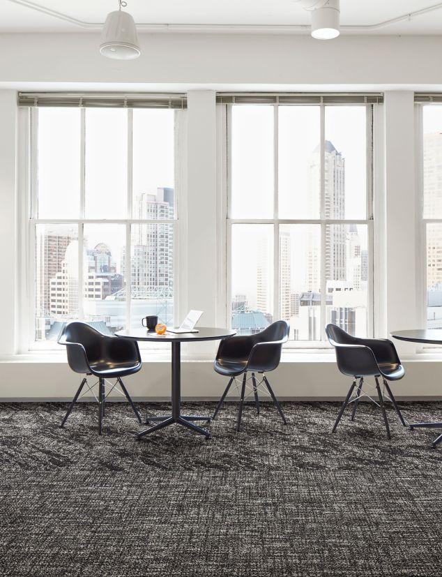 Interface C551 and C552 plank carpet tile in open area with cafe tables and large windows