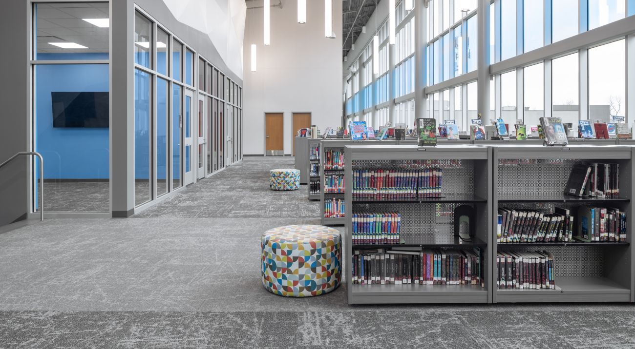 Library in K-12 school with windows lining one wall and Interface carpet installed
