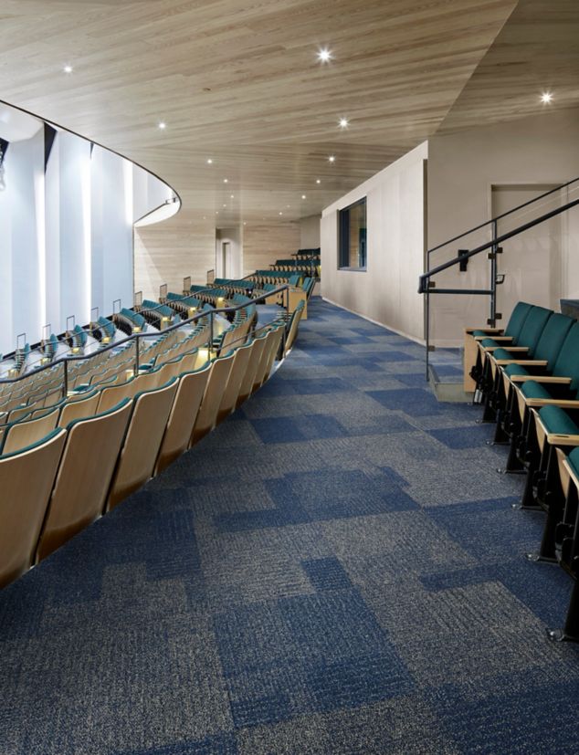 Interface Come and Go carpet tile in theater seating area with wood ceiling