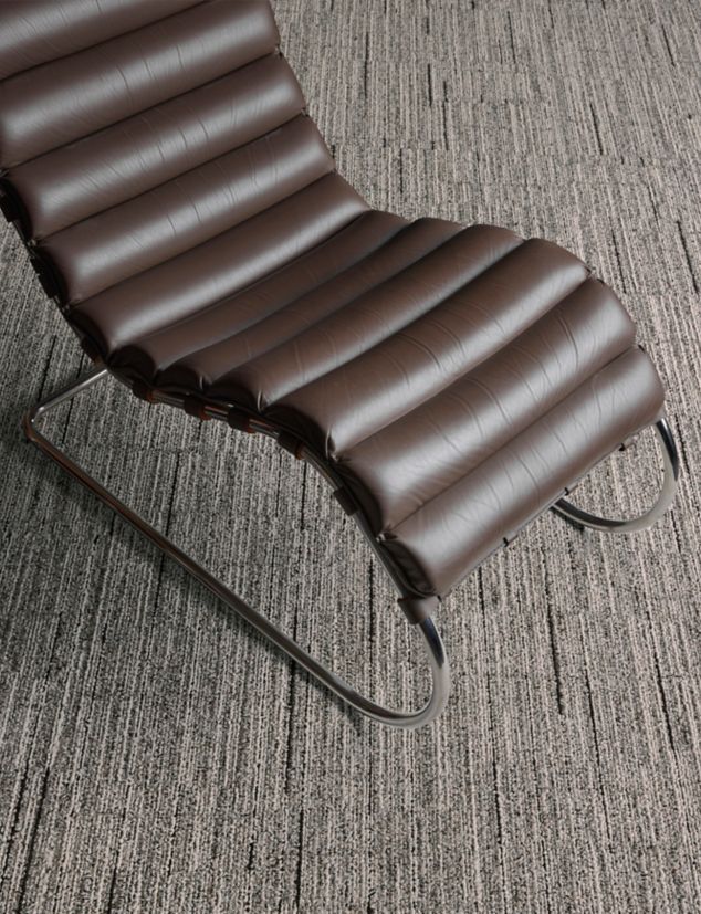Interface Comes Around plank carpet tile in close-up with MR Lounge Chair