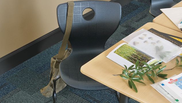 Top down view of Interface Cubic carpet tile in classroom with desk