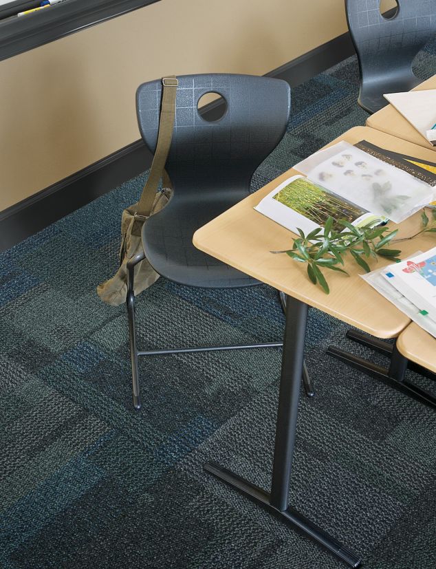 Top down view of Interface Cubic carpet tile in classroom with desk
