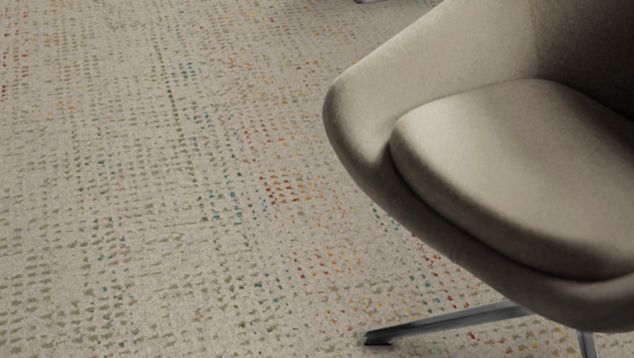 Detail of Interface Speckled plank carpet tile with chair