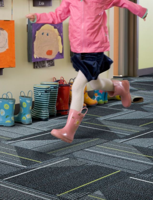 Interface Detours carpet tile in elementary school with child running in corridor 