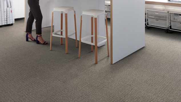 Interface Dover Street carpet tile in work area with standing desk and two chairs