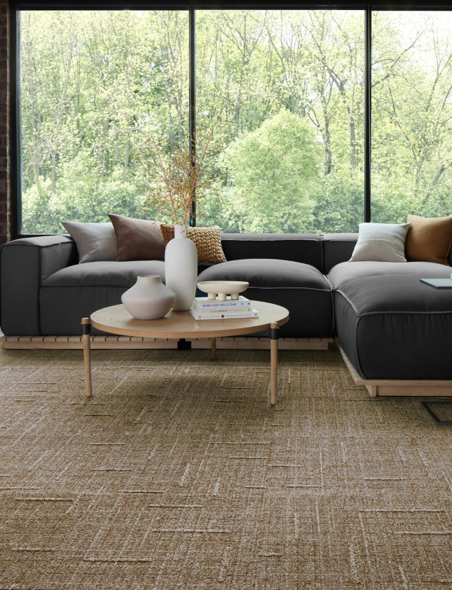 EE711 carpet tile in workplace lobby or lounge with glass walls and low wraparound sofa