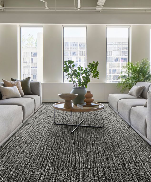 Interface EE714 plank carpet tile in lobby with grey sofas and natural light