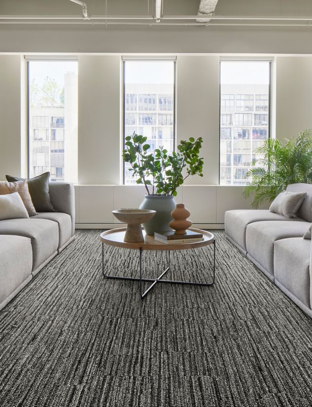 Interface EE714 plank carpet tile in lobby with grey sofas and natural light