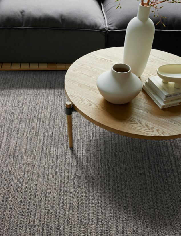 Interface EE714 plank carpet tile in seating area with small wood table