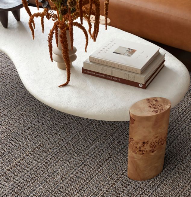 Interface E615 plank carpet tile in lobby with stone coffee table and brown sofa