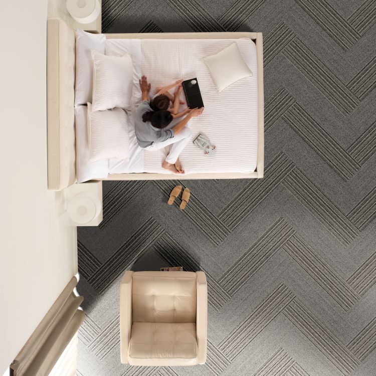 Interface WW860 and WW865 plank carpet tile in hotel guest room with woman and child on bed