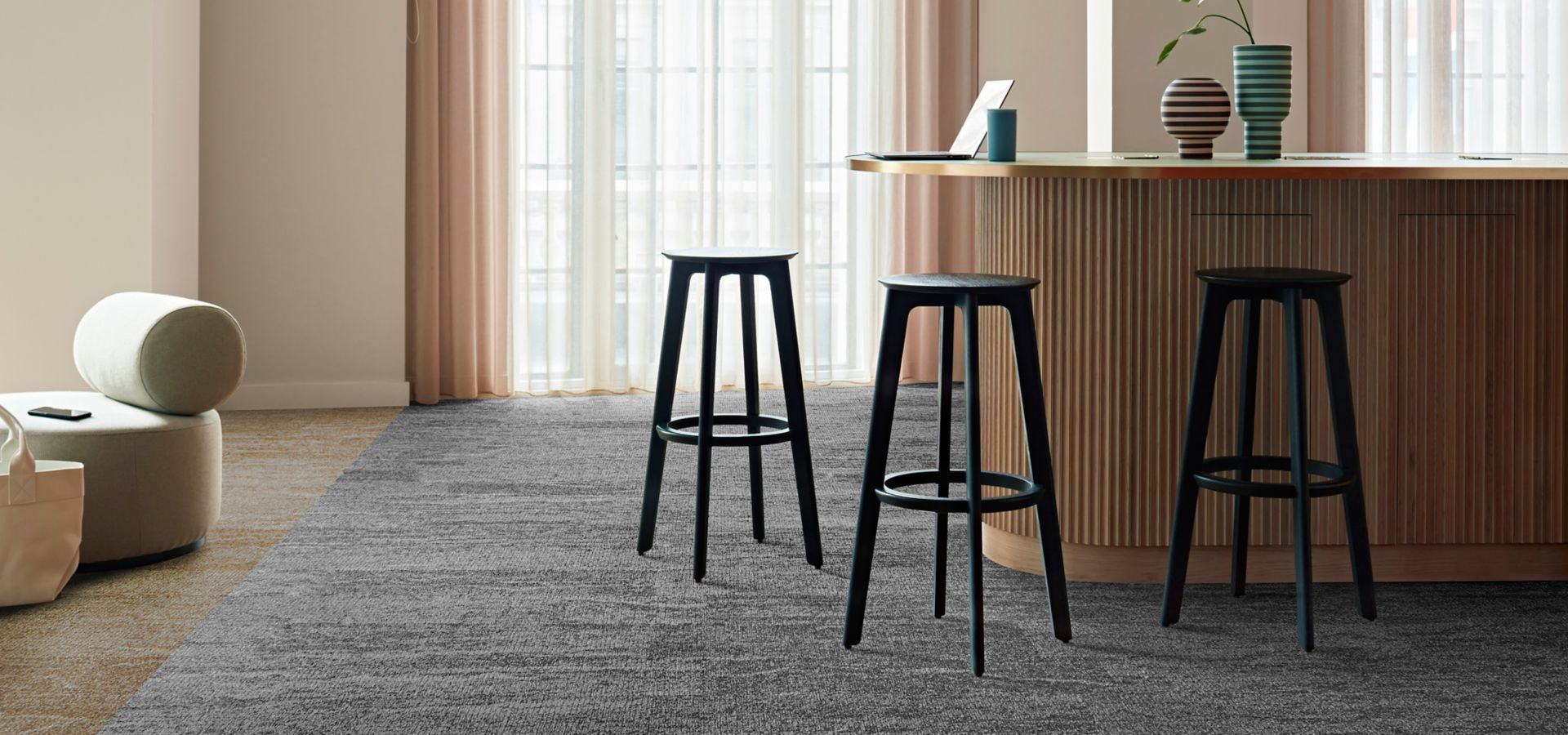 Interface Free Reign plank carpet tile in reception area with striped vases