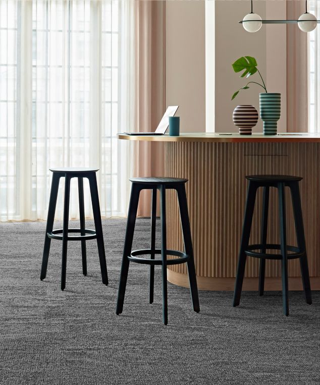 Interface Free Reign plank carpet tile in reception area with striped vases