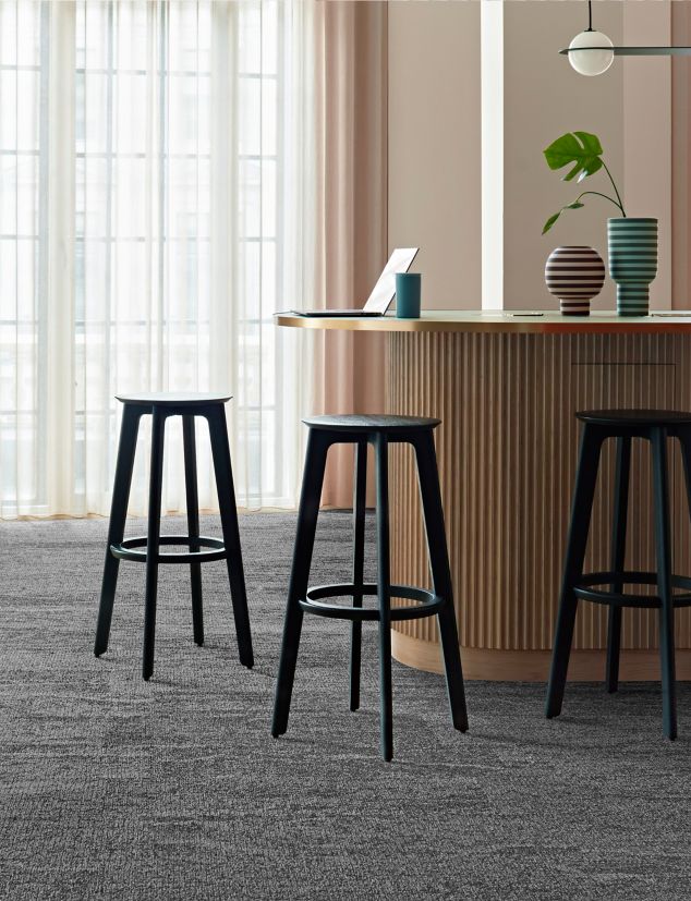 Interface Free Reign plank carpet tile in reception area with striped vases