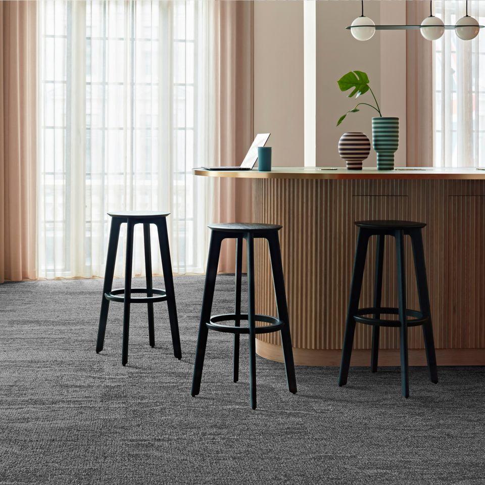 Interface Free Reign plank carpet tile in reception area with striped vases