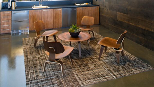 FLOR's Full Kilt carpet tile in modern office seating area with wood chairs and table