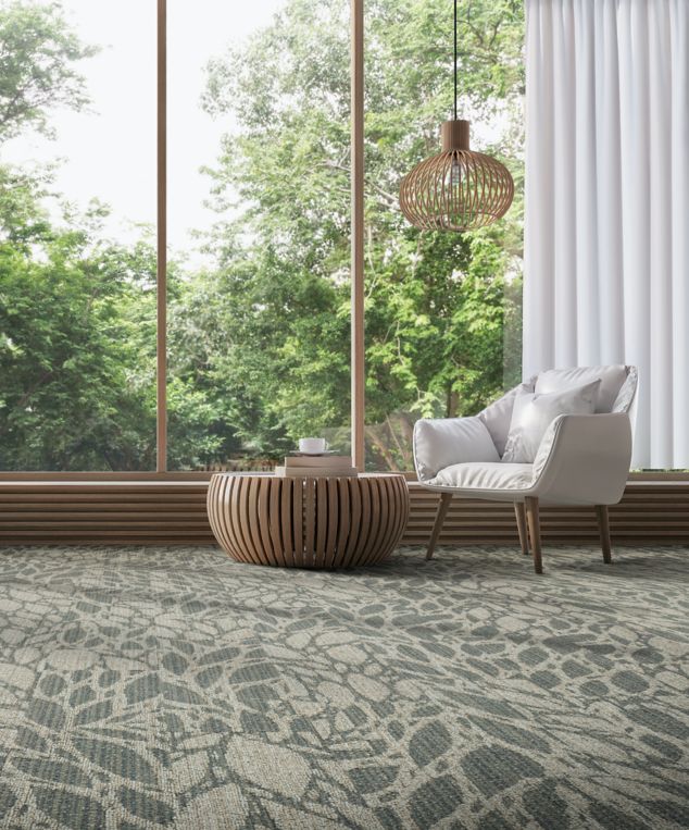 Interface GN157 plank carpet tile in public space with white accent chair
