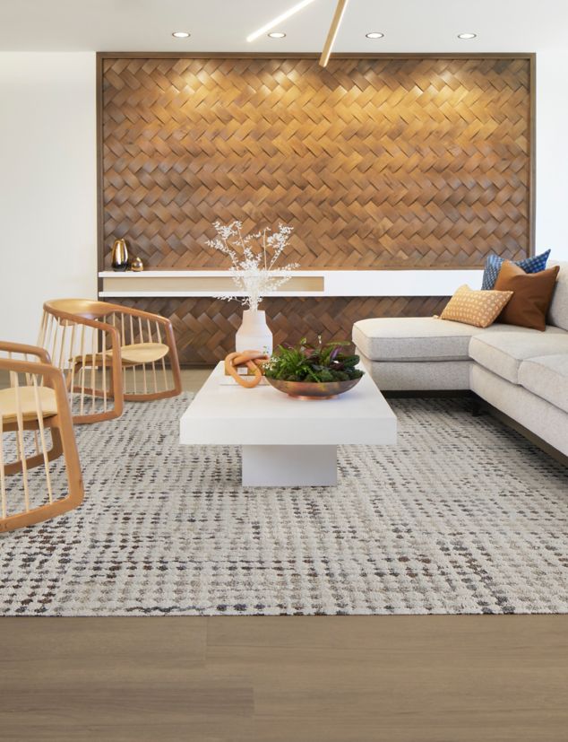 Interface Gossamer carpet tile with On Grain plank LVT in workplace lobby with exposed brick and modern furniture