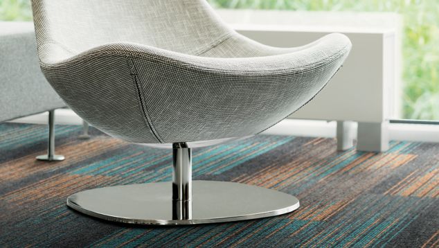 Detail of Interface Ground Waves Verse plank carpet tile with white chair