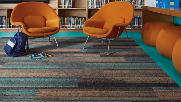 Interface Ground Waves Verse plank carpet tile and Studio Set LVT in library corner