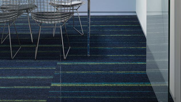 Ground Waves plank carpet tile in focus room with table, chairs and phone