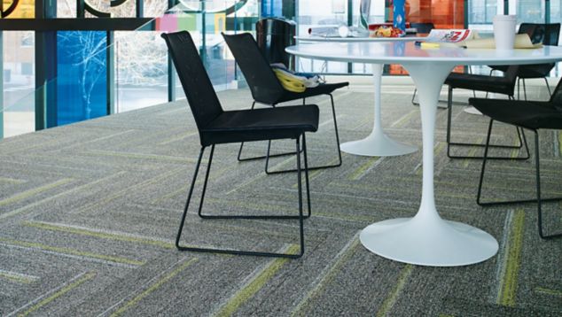 Interface Ground Waves plank carpet tile in casual office corner with tables, chairs and laptops