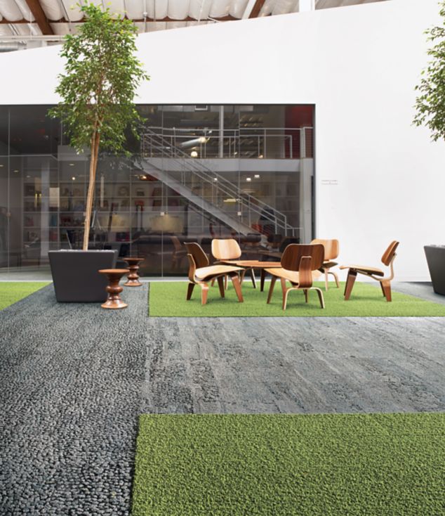 Interface HN810, HN830, HN840 and HN850 plank carpet tiles in open area with wood table and chairs and stairwell in the background