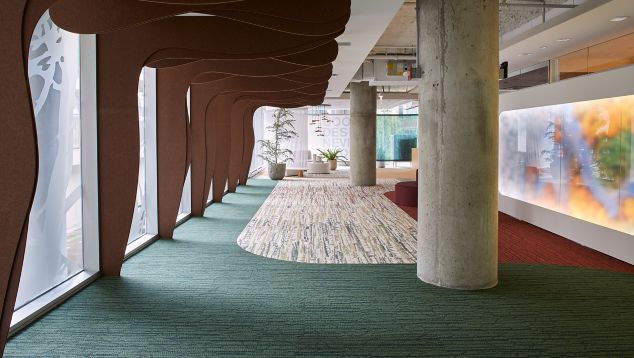Interface Spruce it Up and Shifting Seasons plank carpet tile in corporate showroom corridor