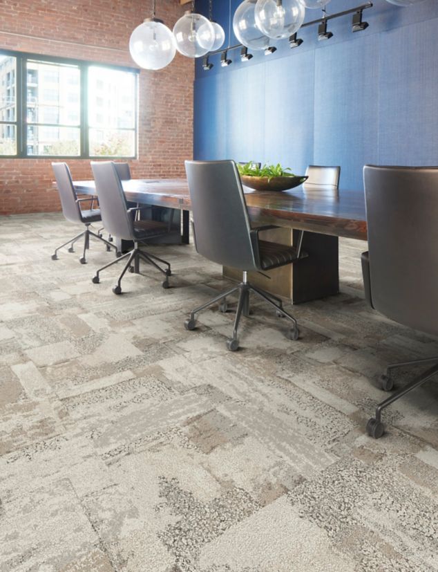 Interface Sun Between carpet tile in meeting room with exposed brick