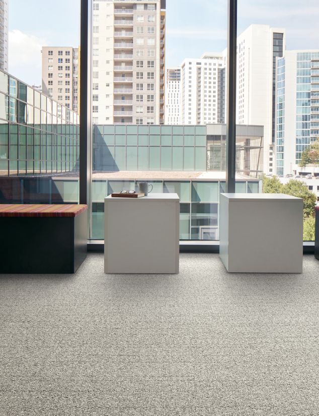 Interface Stitch in Time plank carpet tile with tables and chairs facing outside