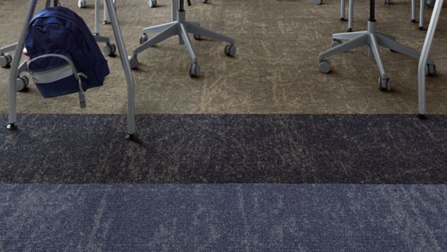 Interface Ice Breaker carpet tile in classroom with two tables surrounded with green chairs