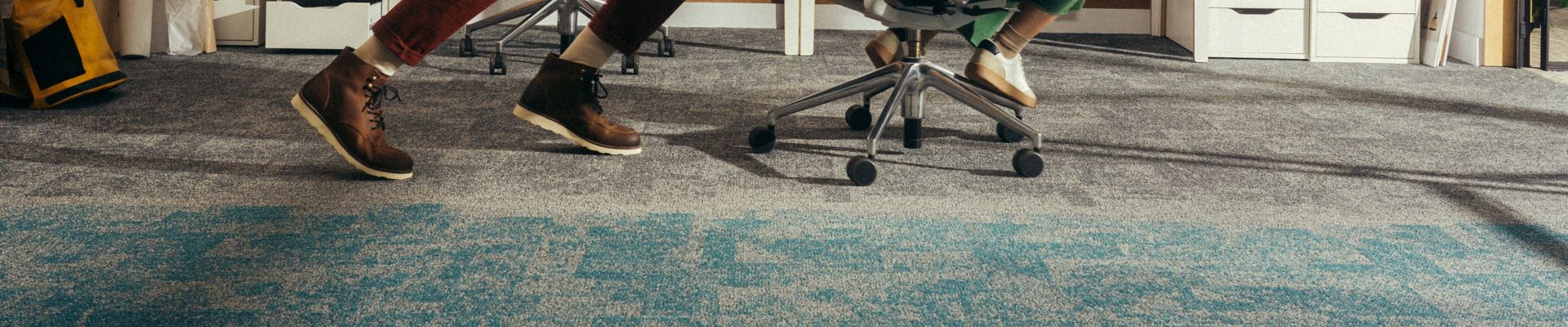 Interface Open Air 404 carpet tile in office with man pushing woman in office chair