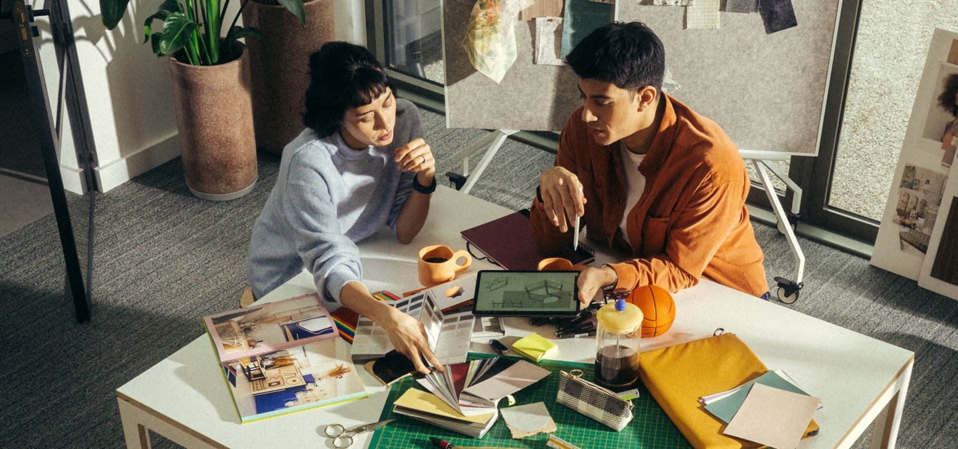 Interface WW860 plank carpet tile in work studio with man and woman collaborating