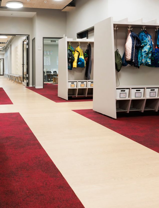 Interface Northern Grain LVT with Composure carpet tile in elementary school corridor and coat room area