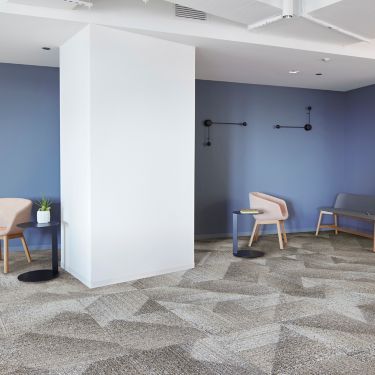 Interface Light Play carpet tile in open workspace area with seating