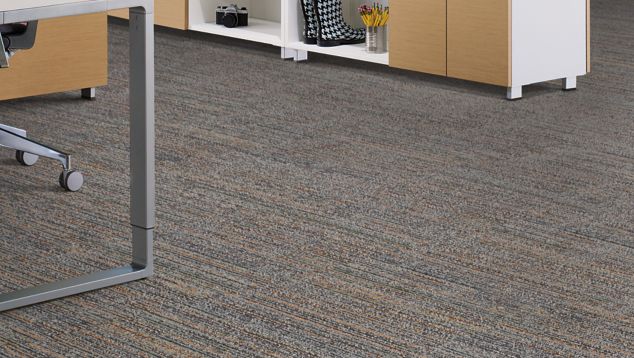 Interface Main Line carpet tile in office area with multiple desks, chairs, and storage compartments