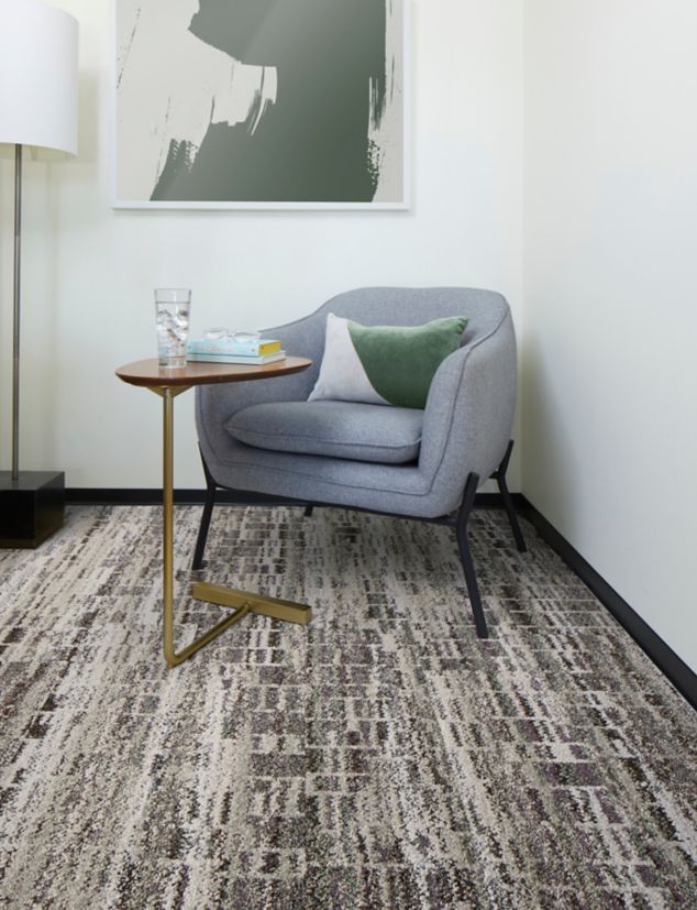 Interface Reflective Sky plank carpet tile in corner of office with small table and chair